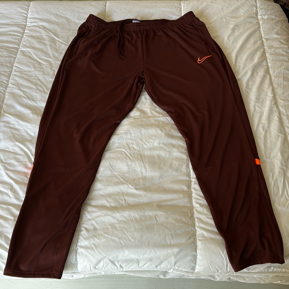 Nike Dri-Fit Joggers, Burgundy with Neon Orange Stripes.